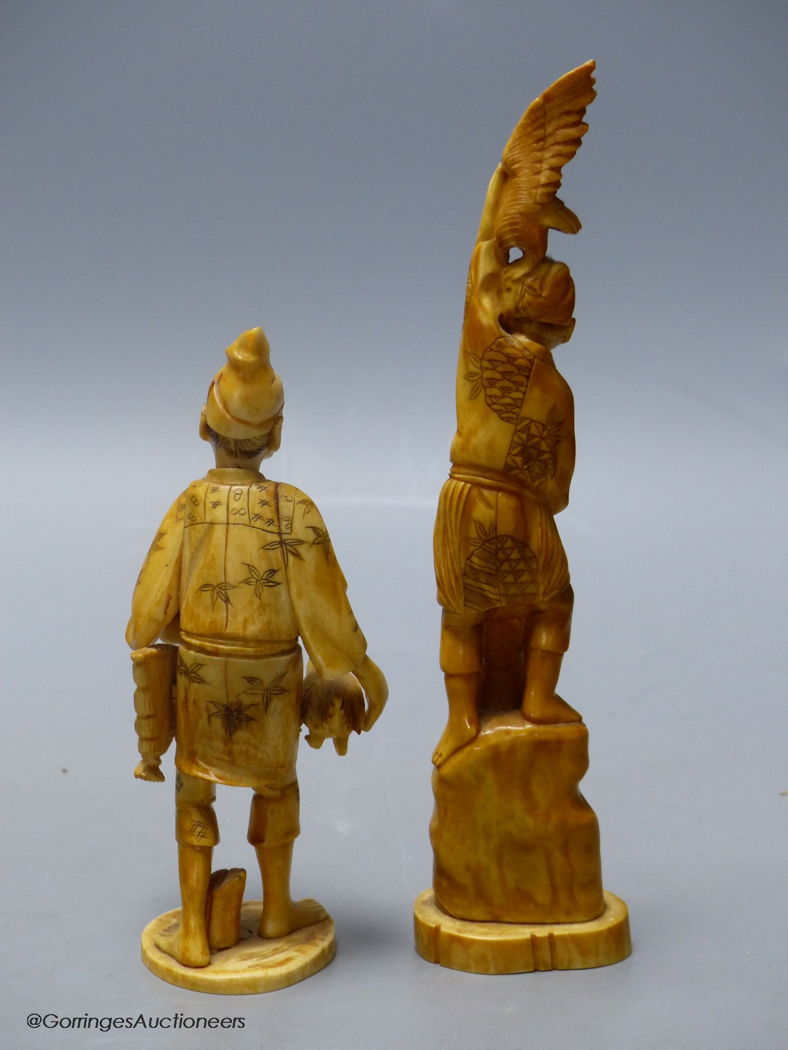 A Japanese walrus ivory figure of a cormorant fisherman and a sectional ivory figure of a farmer